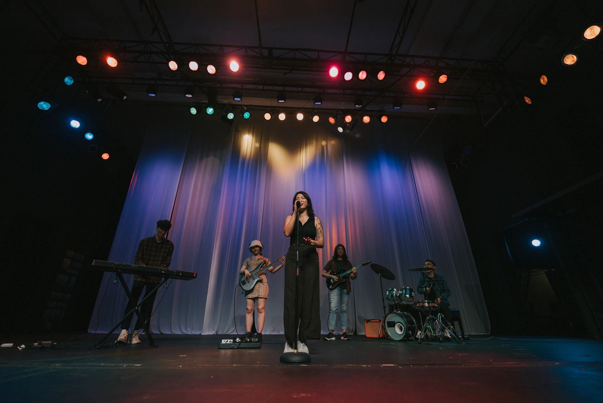 Live band performance with singer and musicians on stage