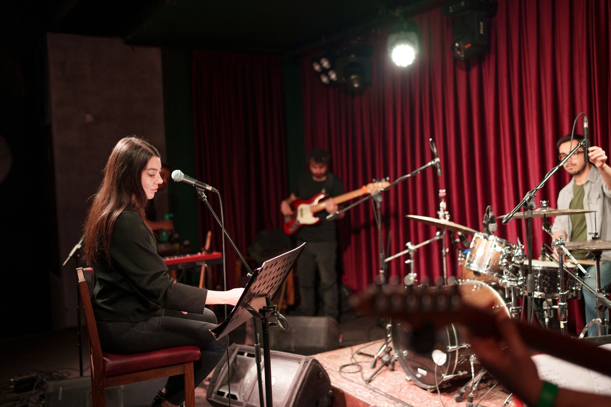 Band rehearsing together on stage before a show